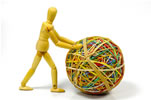 Model man pushing ball of rubber bands